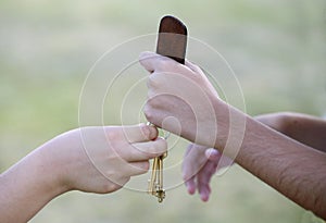 Keys delivery. Two people exchanging keys to a house. Children handing each other keys with key ring. Isolated. House keys.