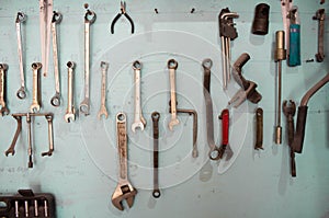 Keys in the garage tools. Old tools hanging on wall in workshop , Tool shelf against a wall  in the garage