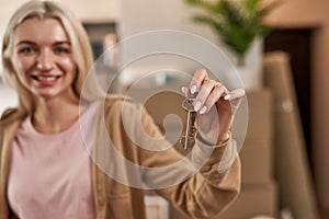 Keys in hand of blurred partial caucasian girl