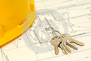 Keys and hat over a construction plan