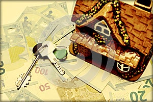 Keys and house on the background of the euro cash