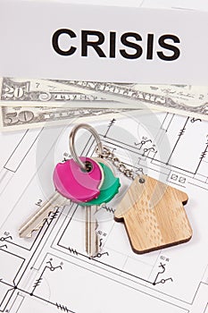 Keys with house shape, dollar and inscription crisis on housing plan. Crisis of real estate market. Reduced housing prices