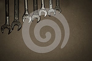 Keys hung on agglomerated wood panel.