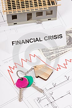 Keys, inscription crisis, dollars and downward graphs representing financial crisis of real estate market. Reduced housing prices