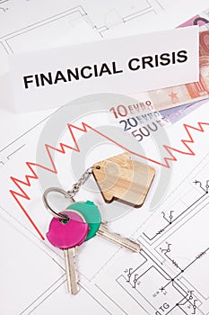 Keys, inscription crisis, euro and downward graphs representing financial crisis of real estate market. Reduced housing prices