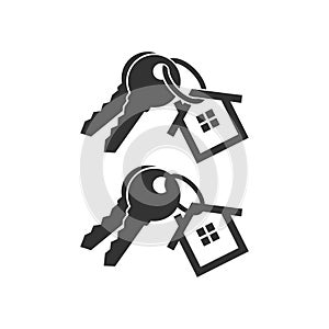 Keys with key chain ring and a house pendant. Pair of house keys.