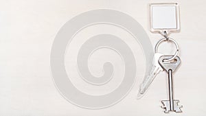 Keys on keyring with blank white keychain on board