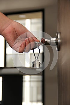 Keys with keyring in the shape of a house open door of real estate delivery of a new house and security at the entrance