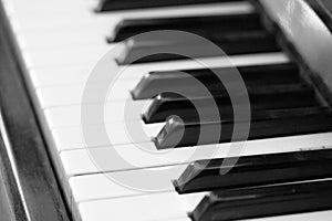 The keys of an old piano closeup. Musical background black and white