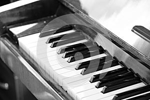 The keys of an old piano closeup. Musical background black and white