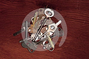 The keys are stacked on a wooden surface