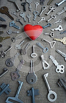 Keys strive to the red heart, vertical conceptual photo