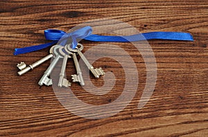 Keys tied together with a blue ribbon