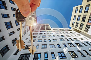 The keys to the apartment in the background of the facade of the house .