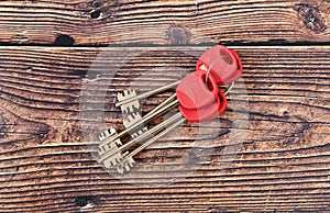 The keys to the front door of a private house or apartment lie on a wooden background