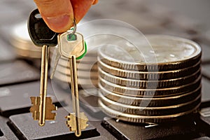 The keys to a private house on a background of money