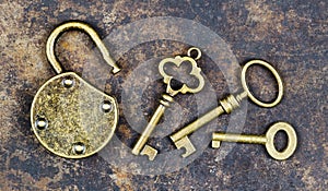 Keys and unlocked padlock on a rusty grunge metal background, escape room concept