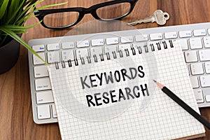 Keywords research concept with computer and key