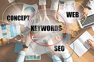 Keywords research concept. Team of SEO specialists working at table