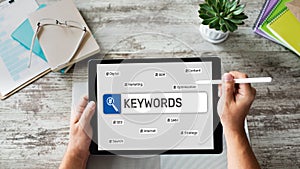 Keywords. SEO, Search engine optimization and internet marketing concept on screen.