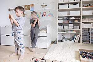 Khabarovsk, Russia, June 4, 2022. Two male kid playing Lego pieces on floor at childish room