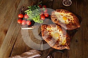 Khachapuri Adjara traditional Georgian dishes. Baked bread stuffed with cheese and eggs.