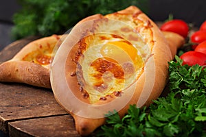 Khachapuri in Adjarian. Open pie with mozzarella and egg.