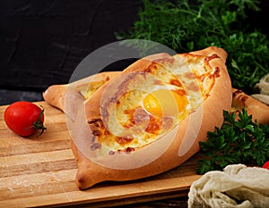 Khachapuri in Adjarian. Open pie with mozzarella and egg.