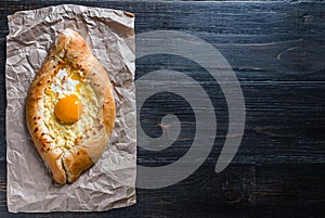 Khachapuri in Adzharian with Adyghe cheese, cheese and yolk. Traditional Caucasian food