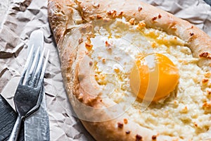 Khachapuri in Adzharian with Adyghe cheese, cheese and yolk. Traditional Caucasian food