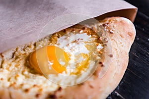 Khachapuri in Adzharian with Adyghe cheese, cheese and yolk. Traditional Caucasian food