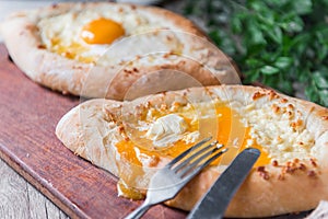 Khachapuri in Adzharian with Adyghe cheese, cheese and yolk. Traditional Caucasian food