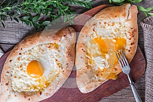 Khachapuri in Adzharian with Adyghe cheese, cheese and yolk. Traditional Caucasian food