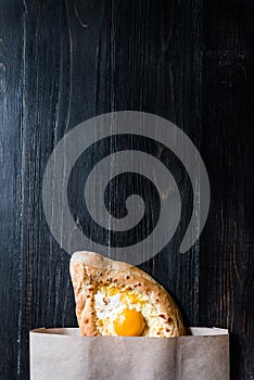 Khachapuri in Adzharian with Adyghe cheese, cheese and yolk. Traditional Caucasian food