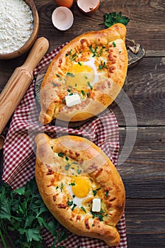 Khachapuri Ajarian on rustic wooden background