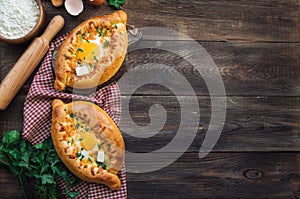 Khachapuri Ajarian on rustic wooden background