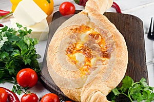 Khachapuri with cheese closeup. Adjarian open pie with mozzarella