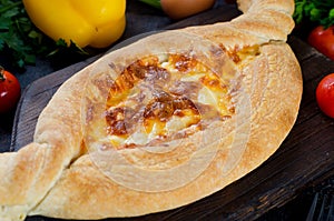 Khachapuri with cheese closeup. Adjarian open pie with mozzarella