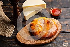khachapuri with cheese on dark wooden background