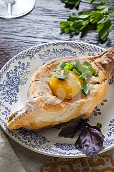 Khachapuri on plate with herbs