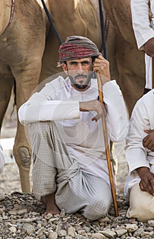 Omani man with his camels before a race