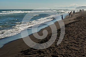 Khalaktyrsky beach with black sand. Pacific Ocean washes Kamchatka Peninsula. photo