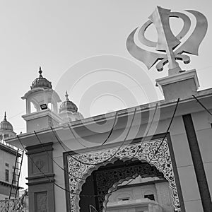 Khanda Sikh holy religious symbol at gurudwara entrance with bright blue sky image is taken at Sis Ganj Sahib Gurudwara in Chandni