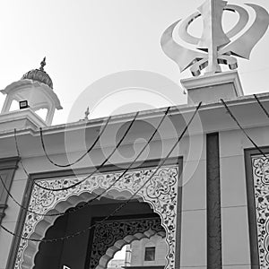 Khanda Sikh holy religious symbol at gurudwara entrance with bright blue sky image is taken at Sis Ganj Sahib Gurudwara in Chandni