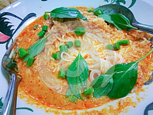Khanom chin serve in white chicken dish. Thai food vintage style.