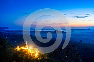 Khao Na Nai Luang Tham Park. Pagoda at sunrise on the top at Khao Na Nai Luang Dharma Park with fog. Beautiful Temple at Surat