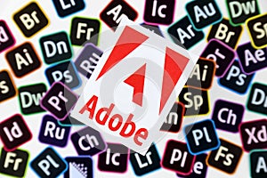 KHARKOV, UKRAINE - DECEMBER 26, 2020: Paper logos of most popular adobe products on white background. Photoshop illustrator bridge