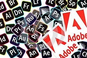 KHARKOV, UKRAINE - DECEMBER 26, 2020: Paper logos of most popular adobe products on white background. Photoshop illustrator bridge