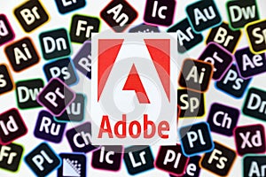 KHARKOV, UKRAINE - DECEMBER 26, 2020: Paper logos of most popular adobe products on white background. Photoshop illustrator bridge