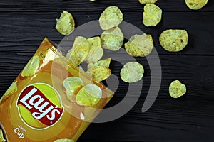 KHARKOV, UKRAINE - JANUARY 3, 2021: Lays potato chips with cheese flavour and original lays logo in middle of package. Worldwide